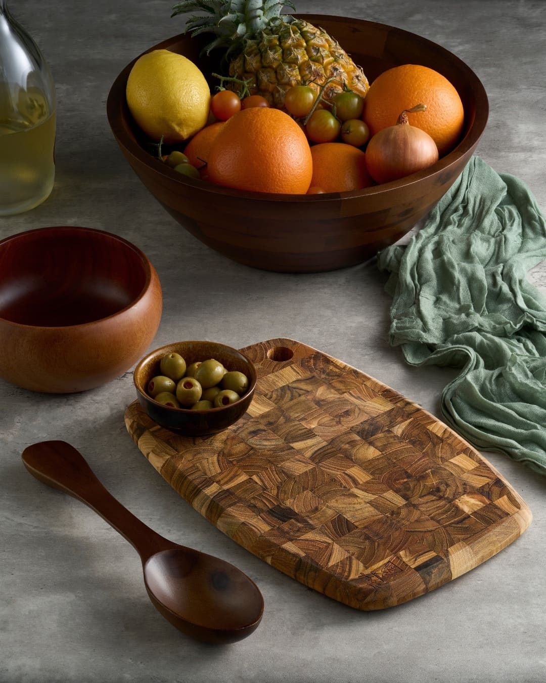 Hale teak cutting board — warm lifestyle scene